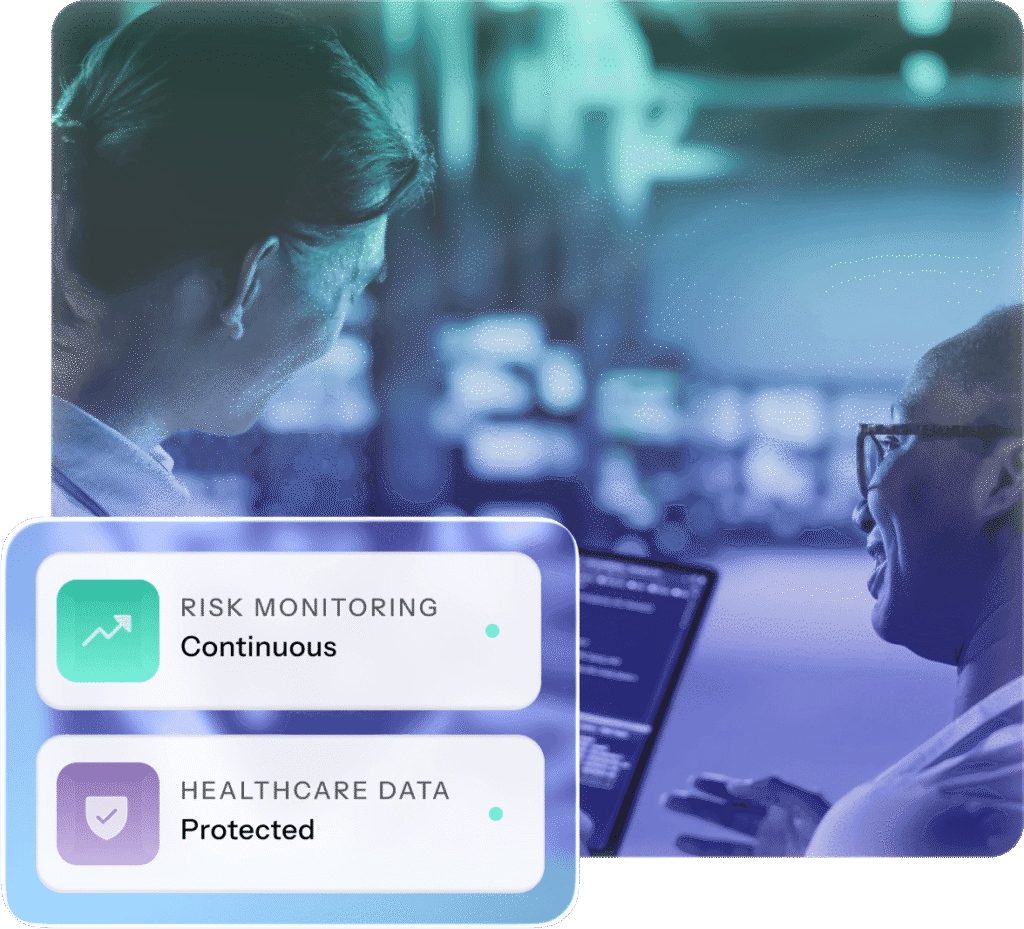 Two people discuss data on a screen in a dimly lit office. Overlay shows "Risk Monitoring: Continuous" and "Healthcare Data: Protected."